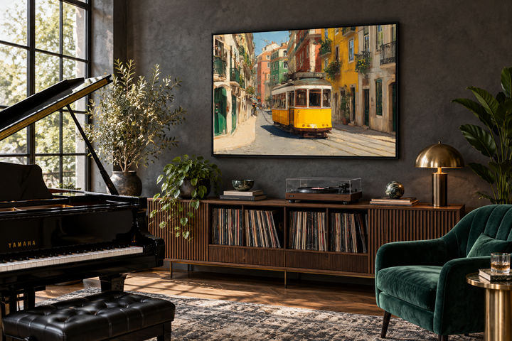 Framed canvas wall art of a yellow Lisbon tram on a colorful sunlit street in a dark modern room.