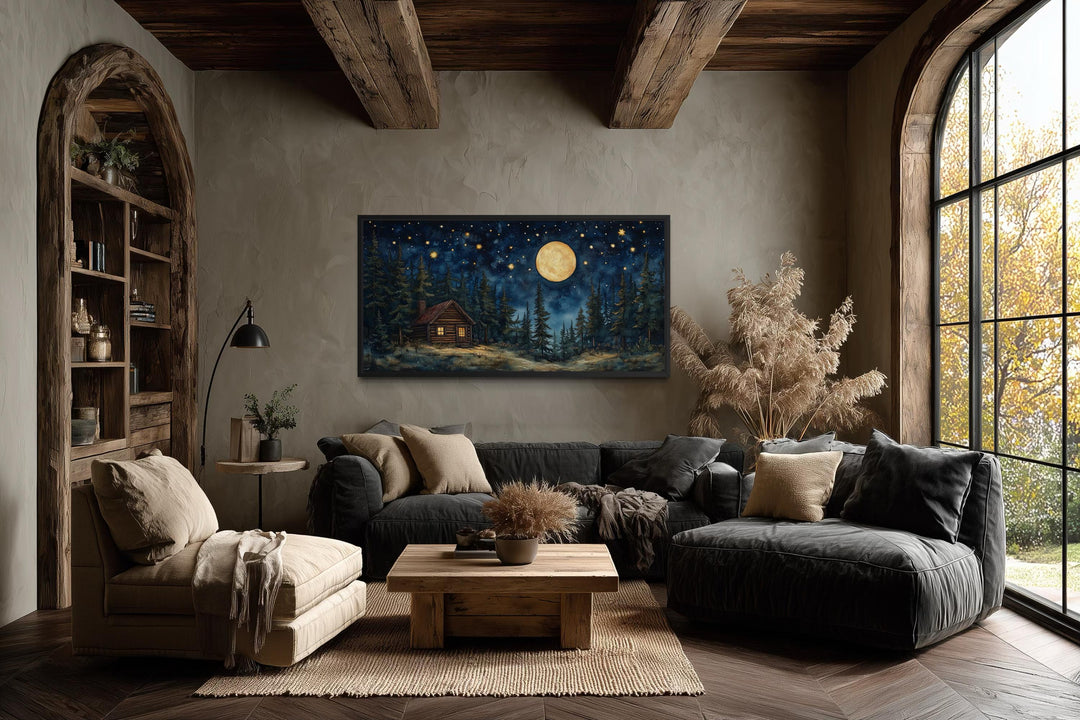 Log Cabin in the Moonlit Woods canvas wall art hanging in a rustic, modern living room.
