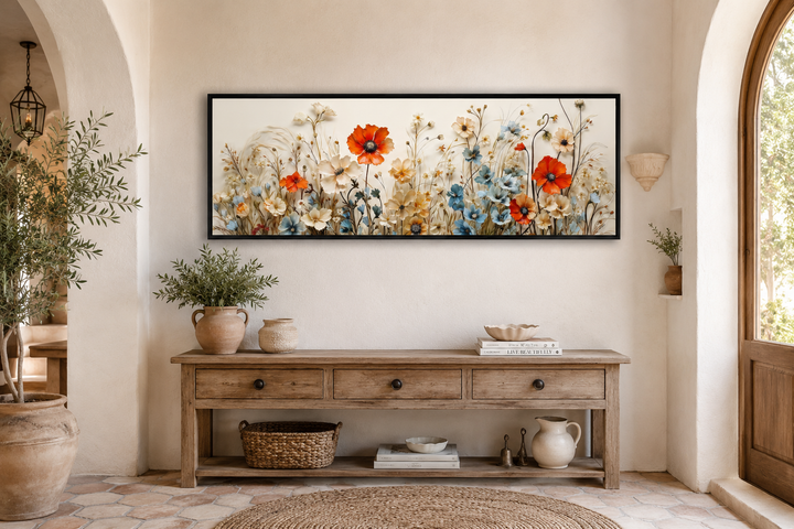 Long horizontal canvas wall art featuring red poppies and blue wildflowers in a neutral room.
