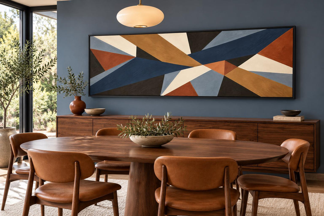 Long horizontal mid-century modern geometric abstract canvas art in earth tones above a sideboard.