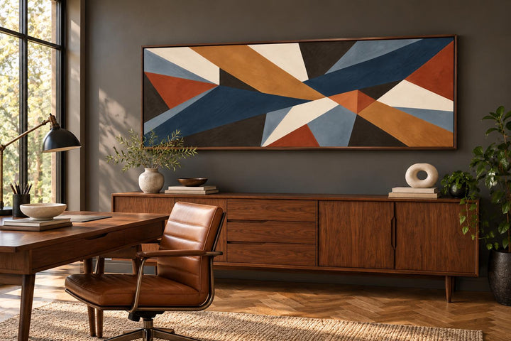 Long horizontal geometric abstract canvas wall art in earth tones above a mid-century modern buffet.