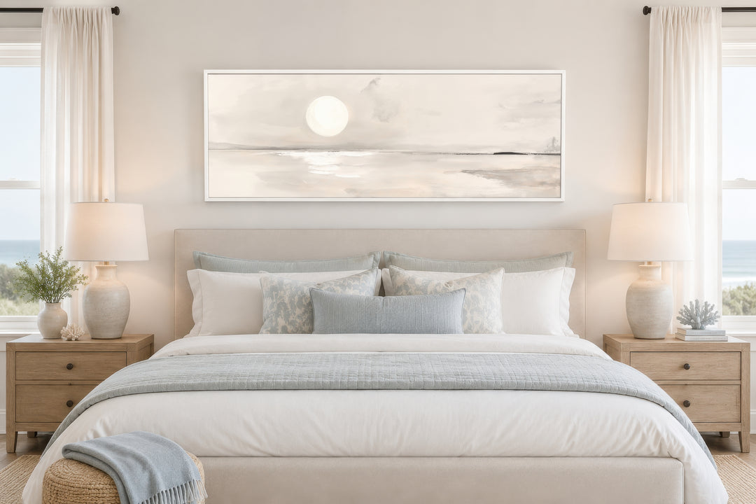 Long horizontal neutral coastal landscape wall art with a moon above a bed in a serene bedroom.