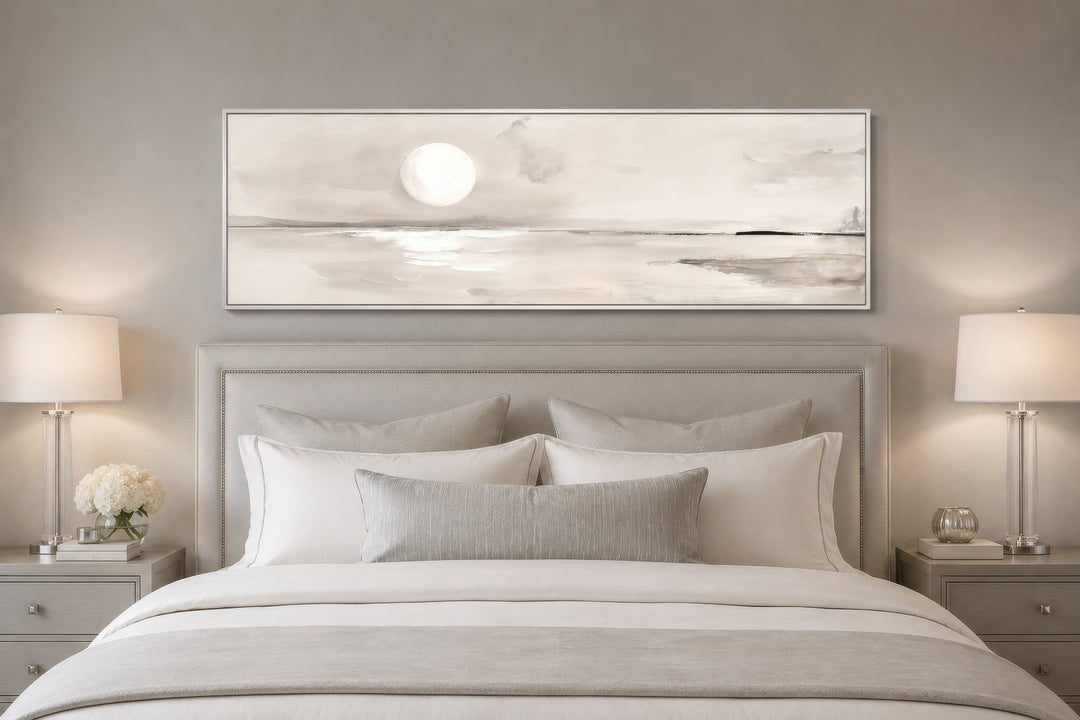 Long horizontal neutral coastal landscape wall art with a moon above a bed in a serene bedroom.