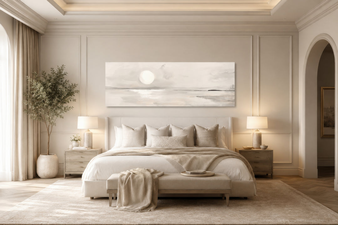 Long horizontal neutral coastal landscape wall art with a moon above a bed in a serene bedroom.