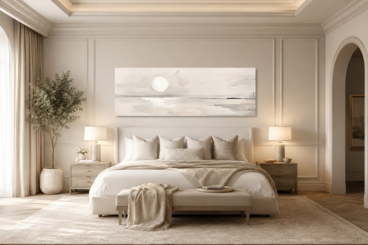 Long horizontal neutral coastal landscape wall art with a moon above a bed in a serene bedroom.