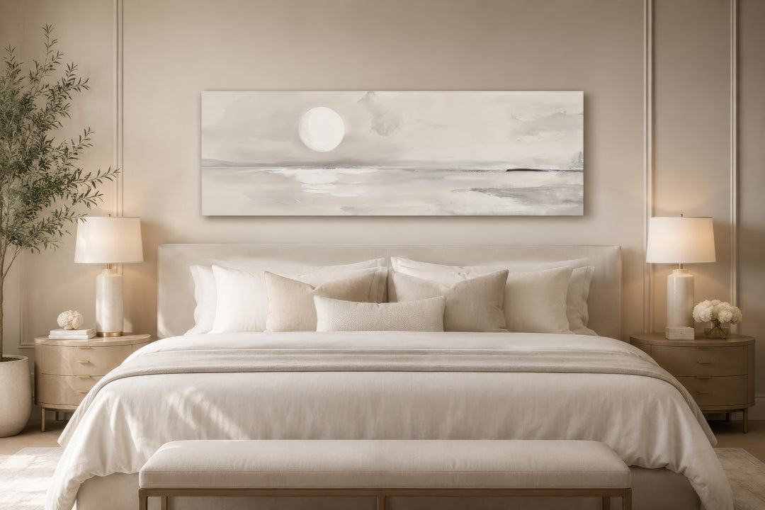 Long horizontal neutral coastal landscape wall art with a moon above a bed in a serene bedroom.