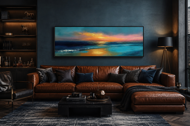 Long horizontal panoramic seascape ocean sunset wall art above a brown leather sofa.