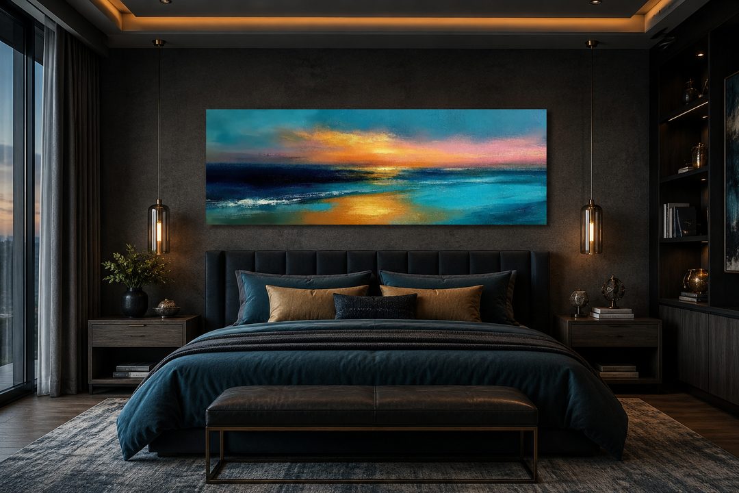 Long horizontal panoramic seascape wall art with ocean sunset in blue, gold, and peach over a bed.