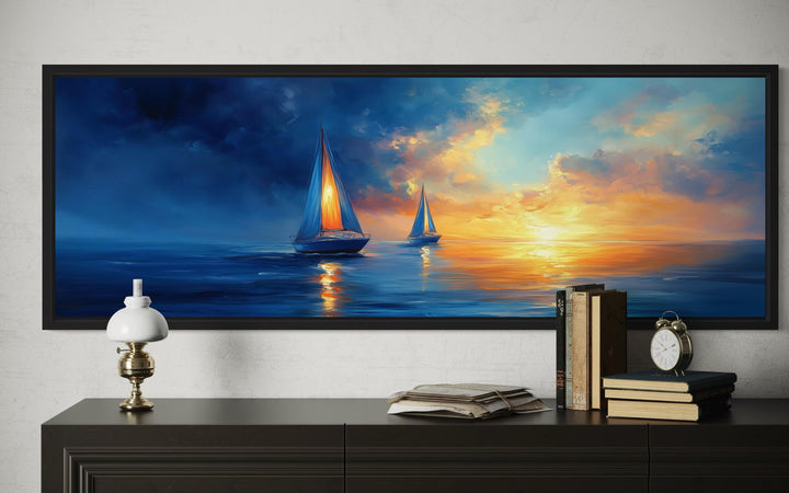 Long horizontal canvas wall art of sailboats on a calm ocean during a vibrant sunset.
