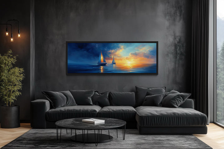 Long horizontal canvas wall art of sailboats on a calm ocean during a vibrant sunset.