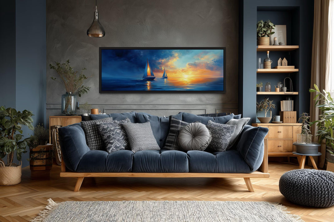Long horizontal canvas wall art of sailboats on a calm ocean during a vibrant orange sunset.