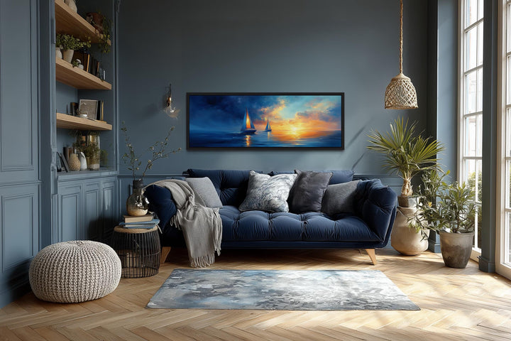 Long horizontal canvas wall art of sailboats on a calm ocean during a vibrant sunset.