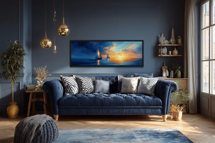 Panoramic canvas wall art of sailboats on a calm ocean during a vibrant orange and blue sunset.