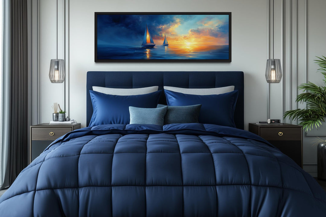 Long horizontal canvas wall art of sailboats on a calm ocean during a vibrant sunset.