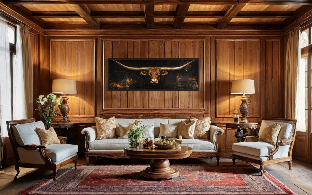Long horizontal Texas longhorn bull head on black rustic canvas wall art above a white sofa.