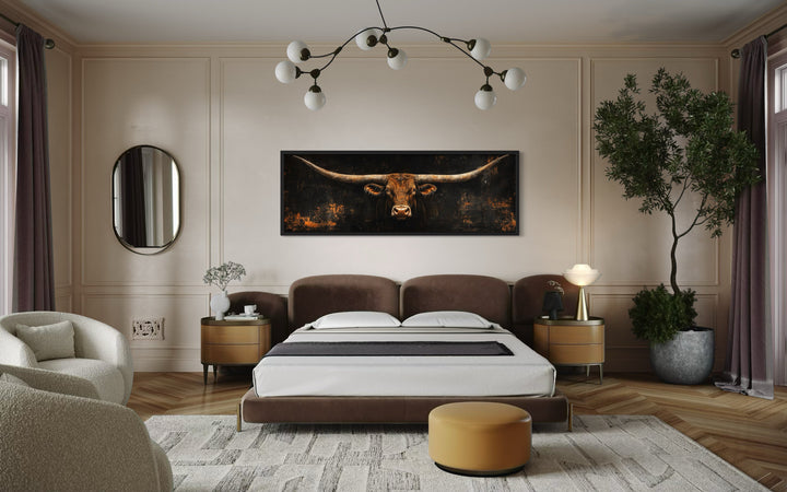 Long horizontal Texas longhorn bull head canvas wall art hanging above a bed in a modern bedroom.