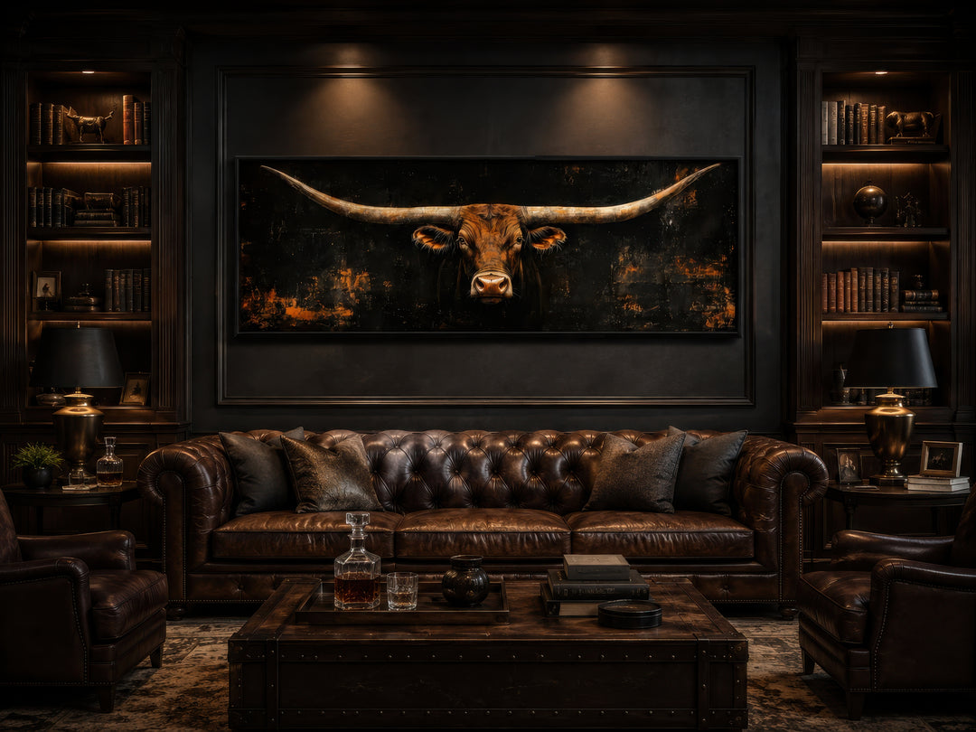 Long horizontal Texas longhorn bull head on a black rustic canvas wall art above a leather sofa.