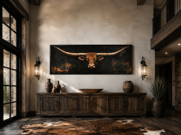 Horizontal Texas longhorn bull head canvas wall art on a black background in a rustic living room.