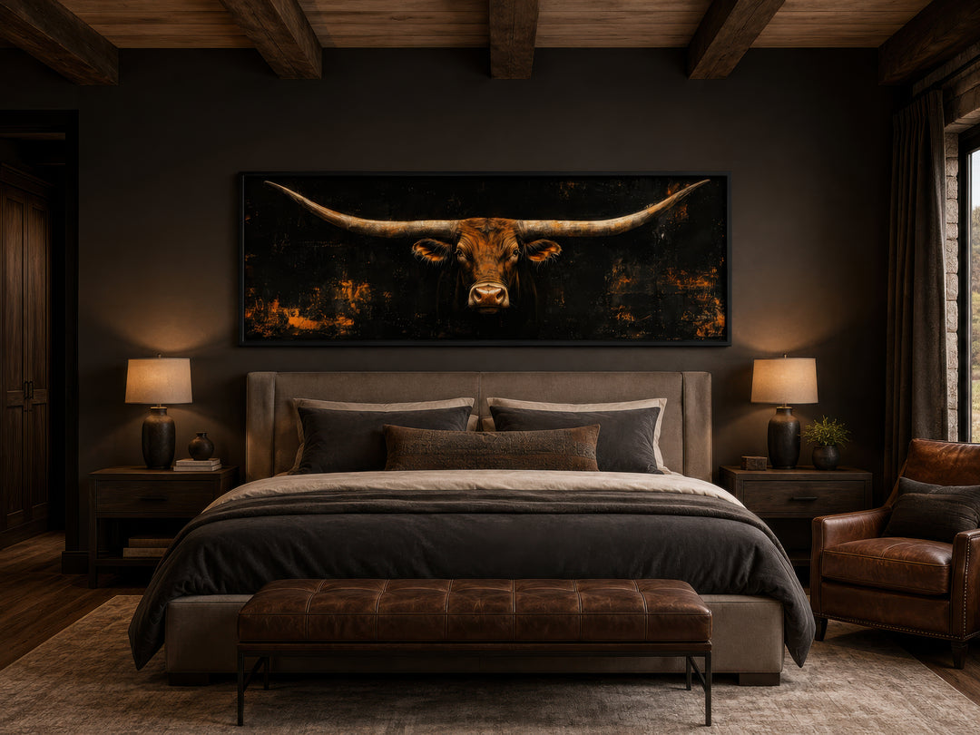Long horizontal Texas longhorn bull head on black rustic canvas wall art above a bed.