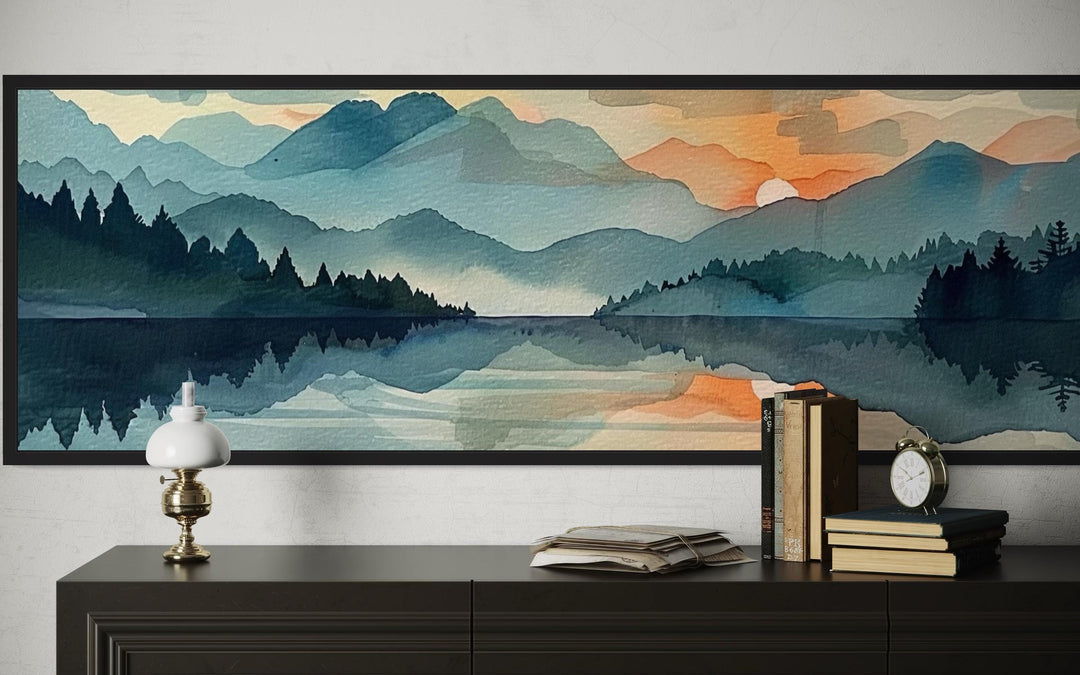 Long horizontal watercolor canvas art of mountain ridges and a sunset reflecting on a calm lake.