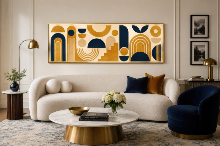 Long narrow Bauhaus canvas wall art with mustard yellow and navy blue geometric shapes over a sofa.