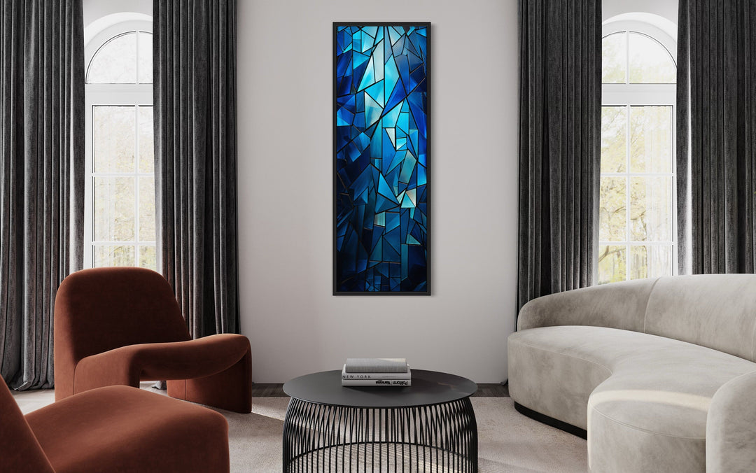 Long narrow vertical framed canvas wall art featuring a navy blue kaleidoscope mosaic pattern.