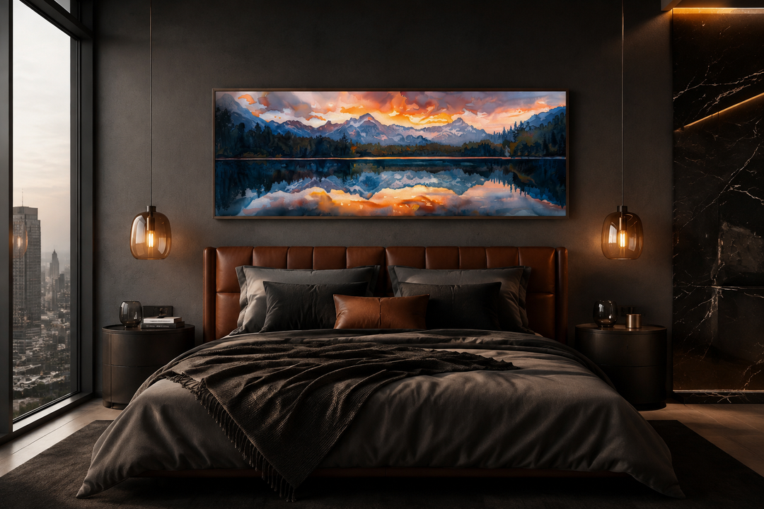 Panoramic framed canvas wall art of a sunset over a mountain lake hanging above a bed.