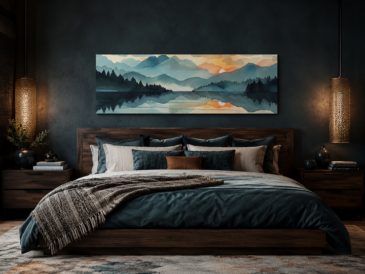 Long horizontal watercolor mountain lake sunset canvas wall art hanging above a dark wood bed.