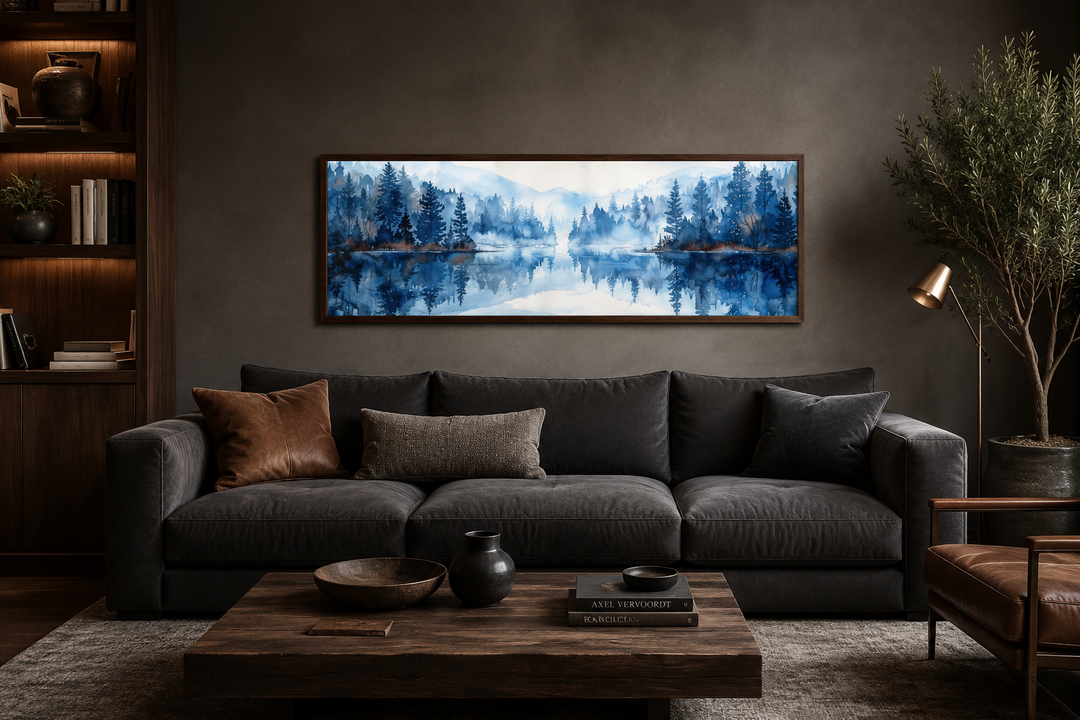 Navy blue lake long narrow horizontal landscape watercolor painting above a dark gray sofa.