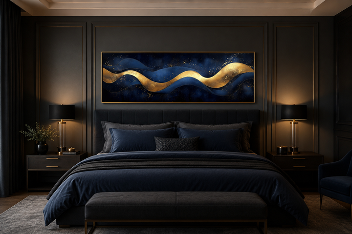 Modern abstract canvas art with navy blue and gold waves hanging above a bed in a dark bedroom.