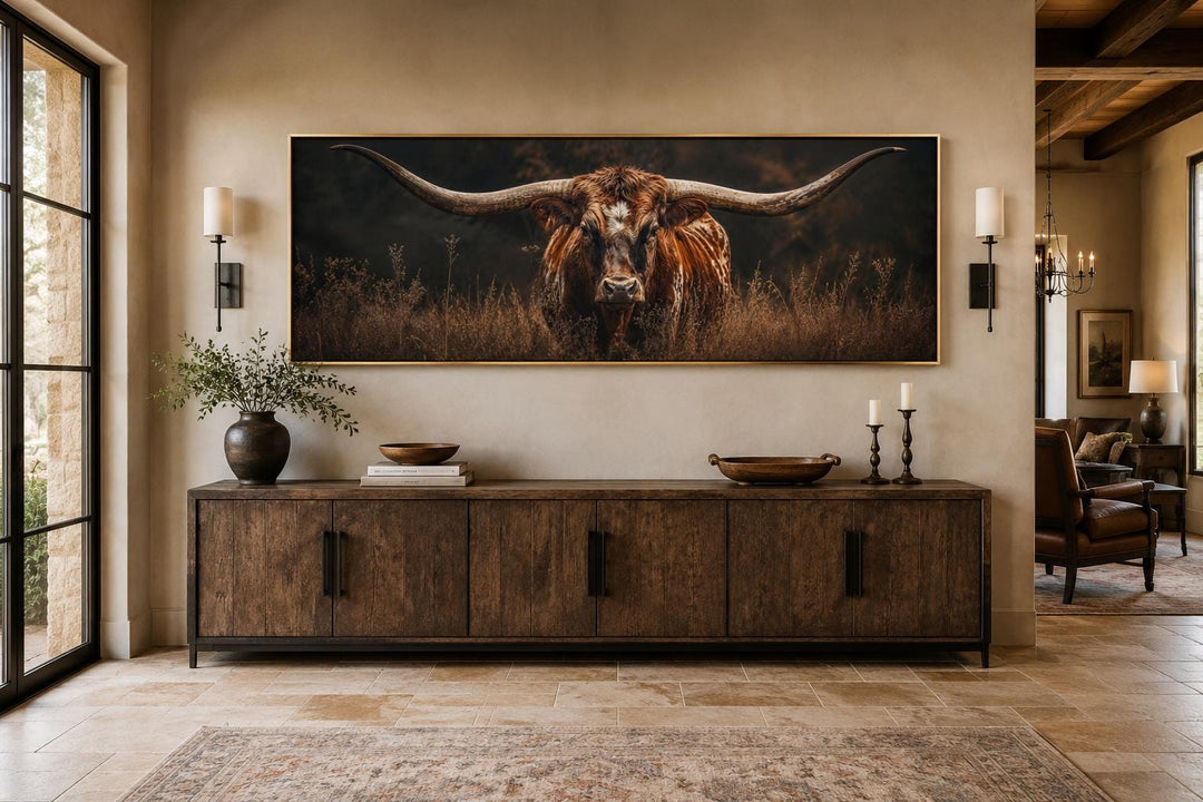 Longhorn bull canvas wall art with sweeping horns above a rustic wooden console table.