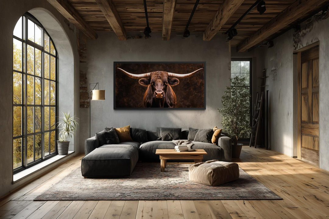 Extra large longhorn bull canvas print in a rustic living room with a dark, moody aesthetic.