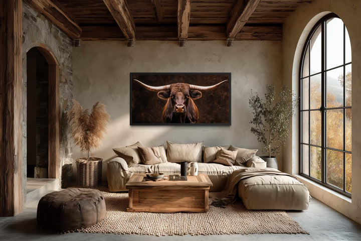 Extra large canvas print of a longhorn bull in a rustic farmhouse living room with wooden beams.