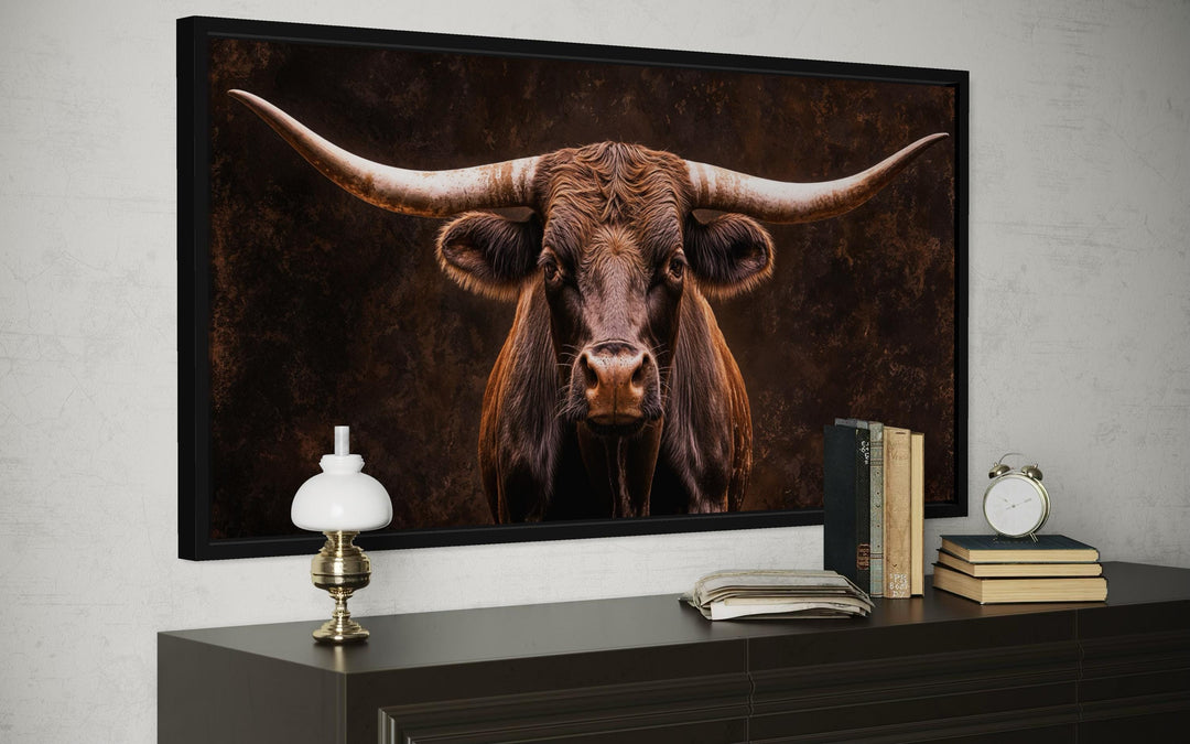 Extra large framed canvas print of a rustic longhorn bull portrait in a dark, moody setting.