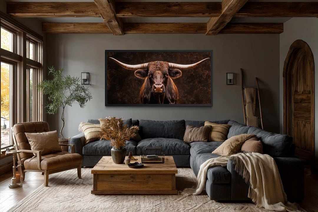 Extra large canvas print of a longhorn bull in a rustic living room with wooden beams.