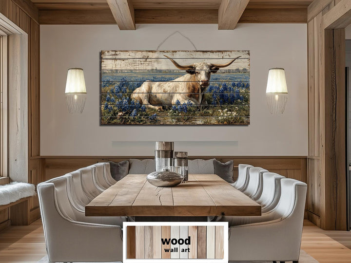 Longhorn in bluebonnet field distressed wood wall art hanging in a rustic farmhouse dining room.
