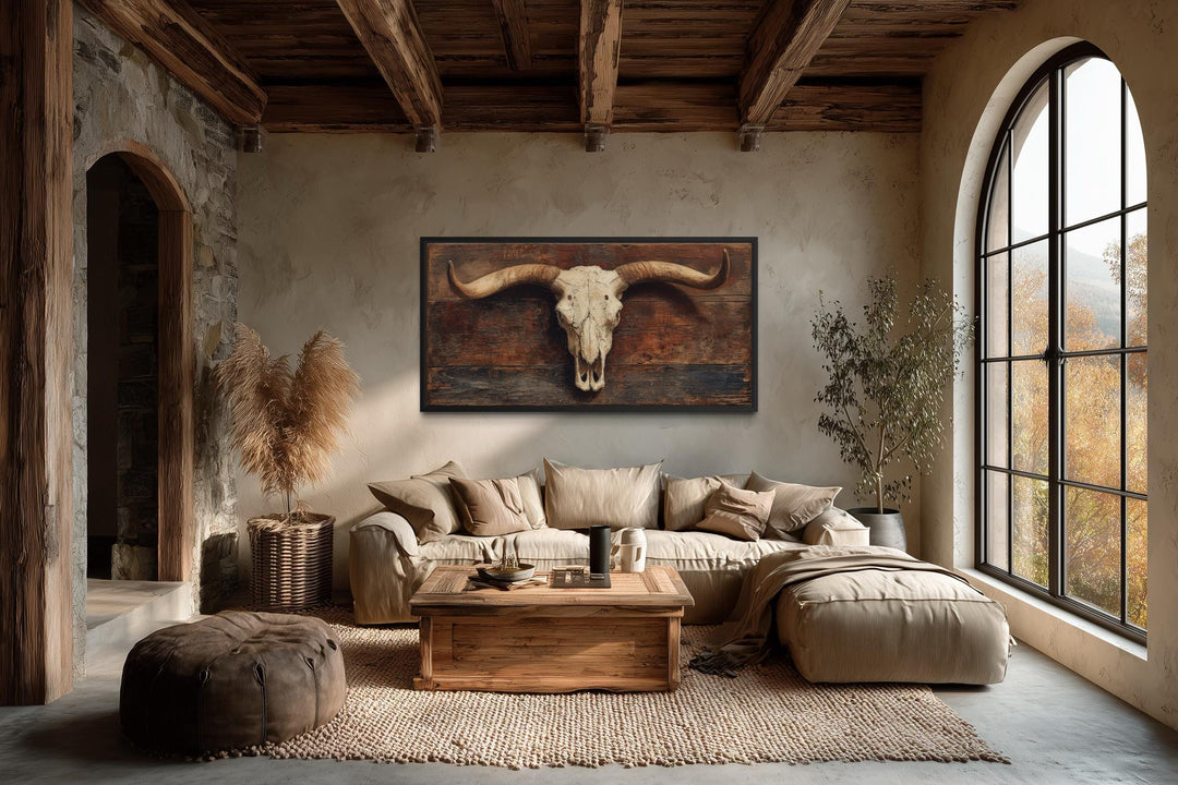 Extra large canvas wall art of a longhorn skull on a rustic brown background in a western living room.