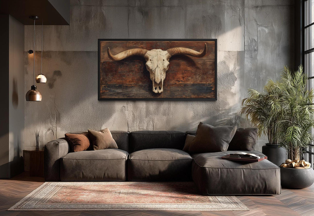 Extra large canvas wall art of a longhorn skull on a rustic brown background in a modern living room.