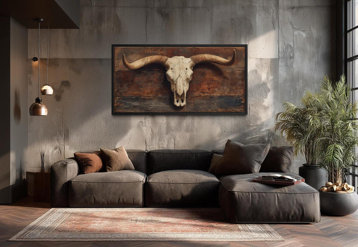 Extra large canvas wall art of a longhorn skull on a rustic brown background in a modern living room.