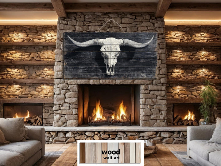 A rustic longhorn skull print on distressed wood panels hanging above a stone fireplace.