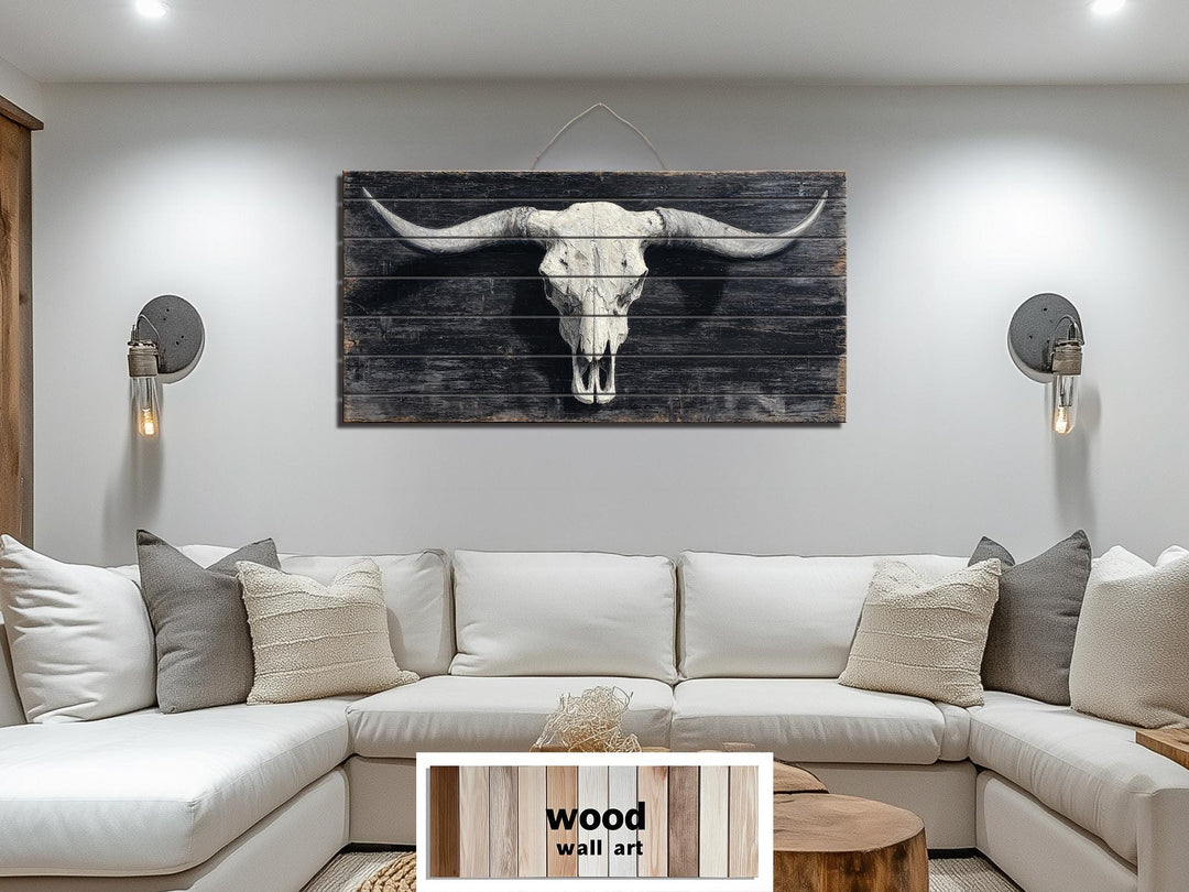 Rustic longhorn skull print on a distressed dark wood panel, centered above a modern white sofa.