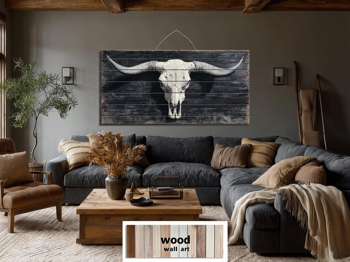 Longhorn skull wall art printed on distressed wood panels in a rustic western living room.