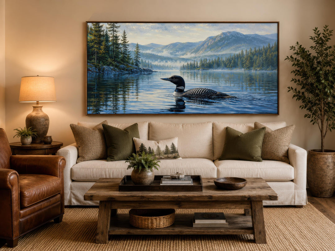 Loon wall art canvas showing a common loon on a misty lake with mountains in a rustic living room.