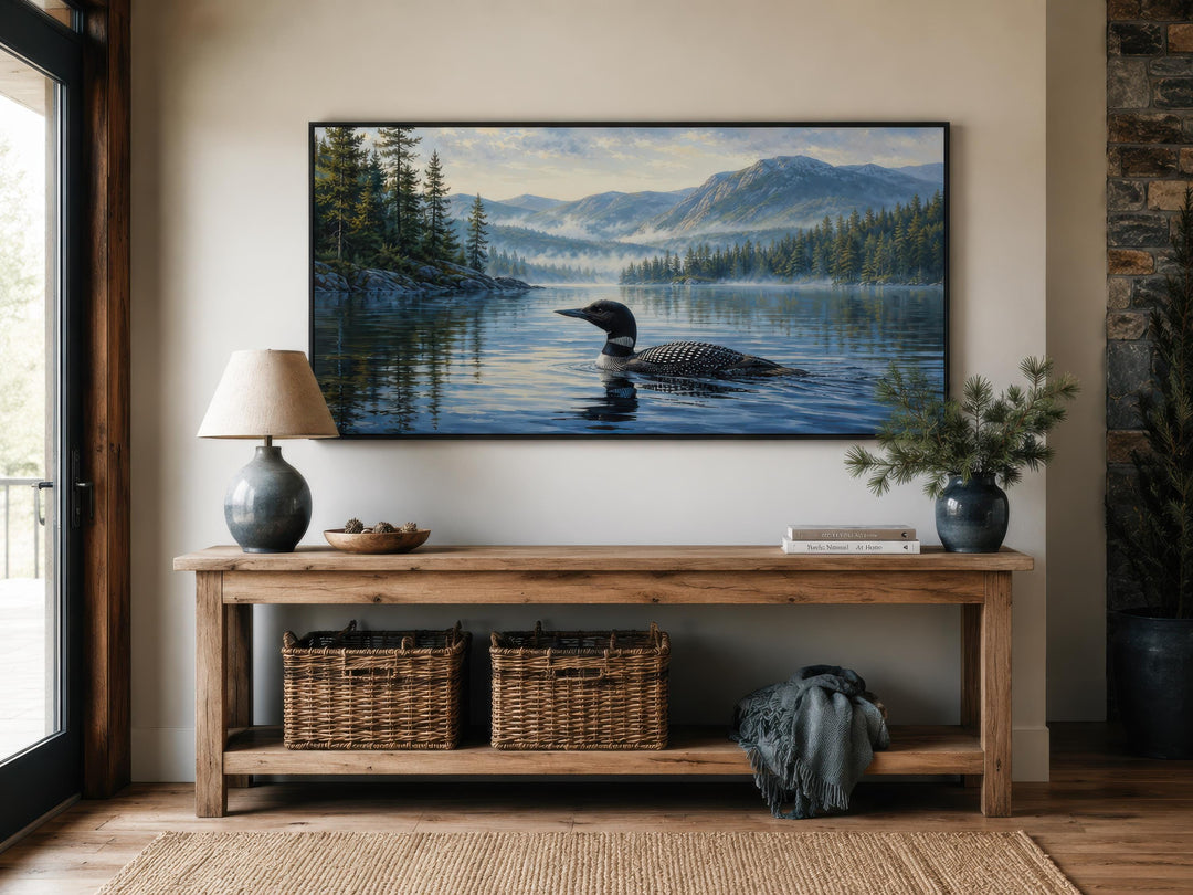 Misty lake canvas wall art featuring a common loon swimming in front of mountains and pine trees.