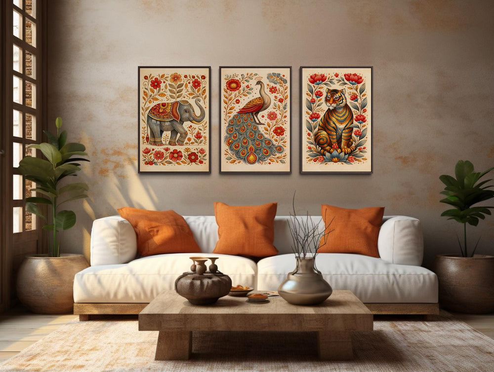 Set of 3 Madhubani animal canvas prints featuring an elephant, peacock, and tiger in a living room.