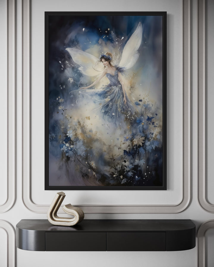 Framed wall art of a fairy with translucent wings dancing among blue flowers in a dreamy forest.