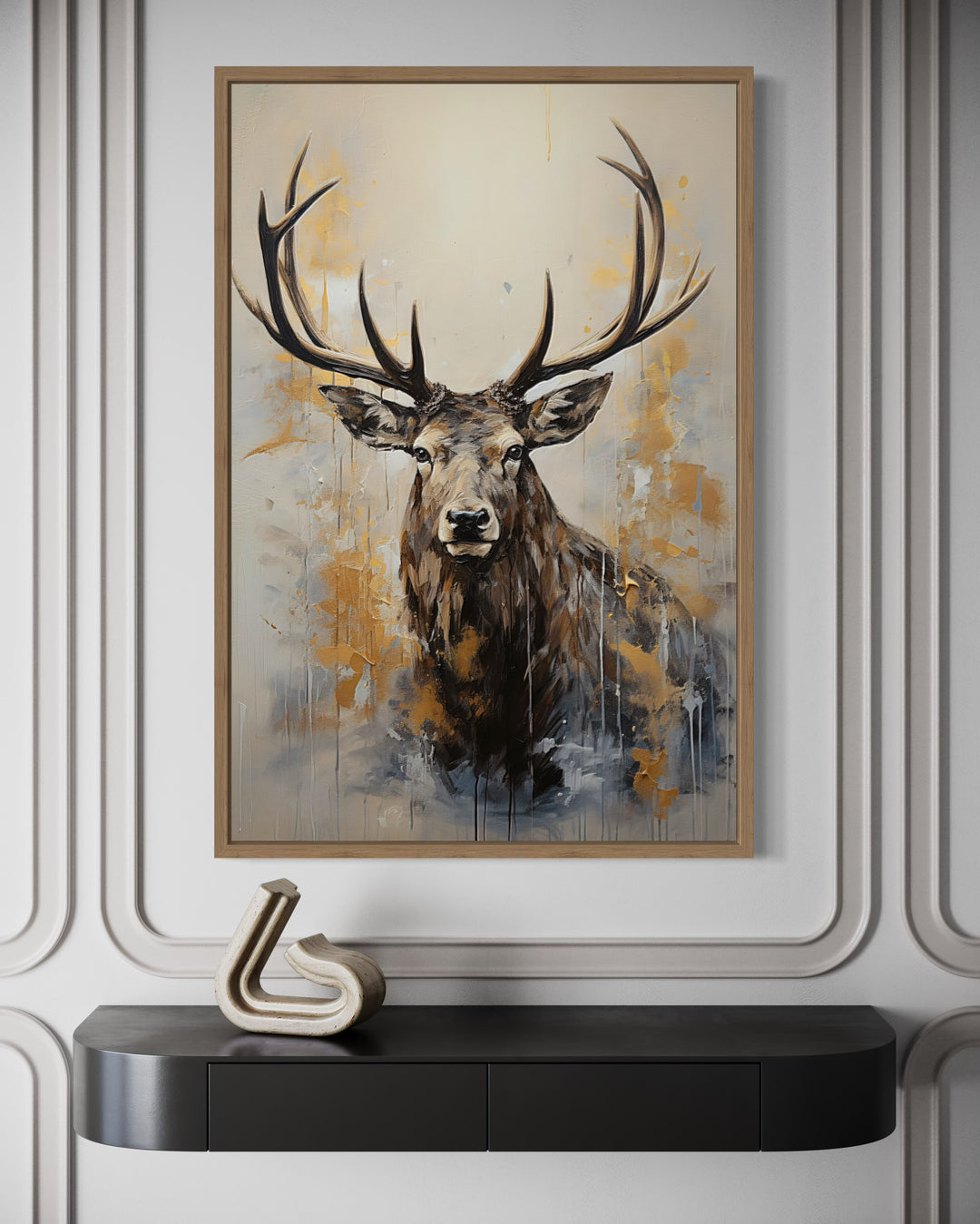 Framed canvas wall art of a majestic elk portrait in beige, gold, and gray above a black console.