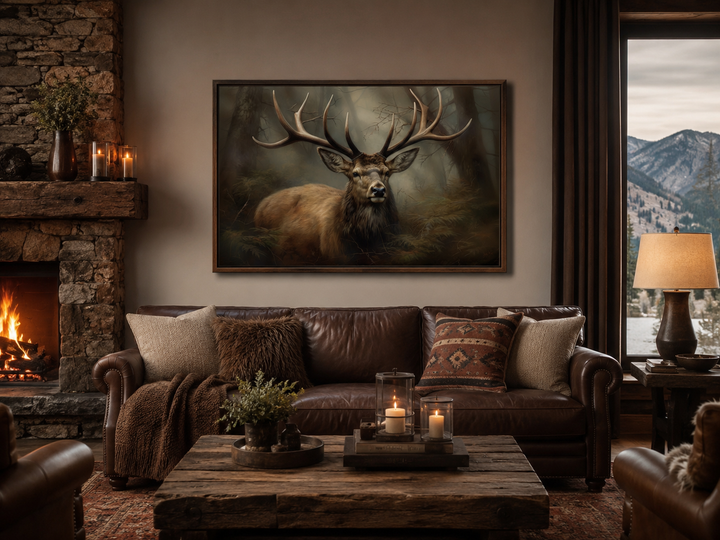 Majestic deer in foggy forest framed canvas wall art hanging above a leather sofa in a rustic cabin.