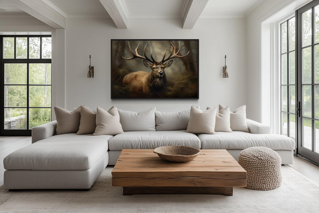 Majestic deer in foggy forest framed canvas wall art hanging above a modern sofa in a cabin living room.