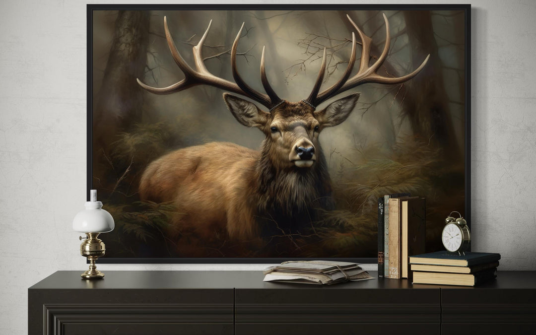 Majestic deer with large antlers in a foggy forest framed canvas wall art above a dark dresser.